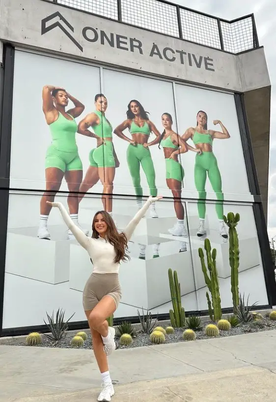 Krissy Cela posing outside her clothing brand