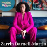 Zarrin Darnell-Martin in pink dress sitting on sofa
